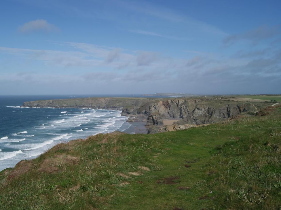 A coastal view with cliffs and ocean waves at Cosy 3 Bedroom House on Cornish estate with pool St Tudy