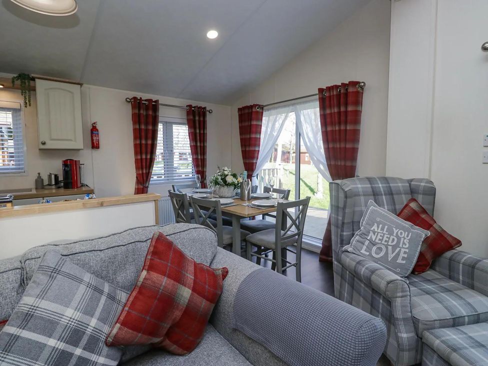 A living room with a sofa and dining area at Lakeland Lodge 3Bed 2 Bath Private Patio in Carnforth