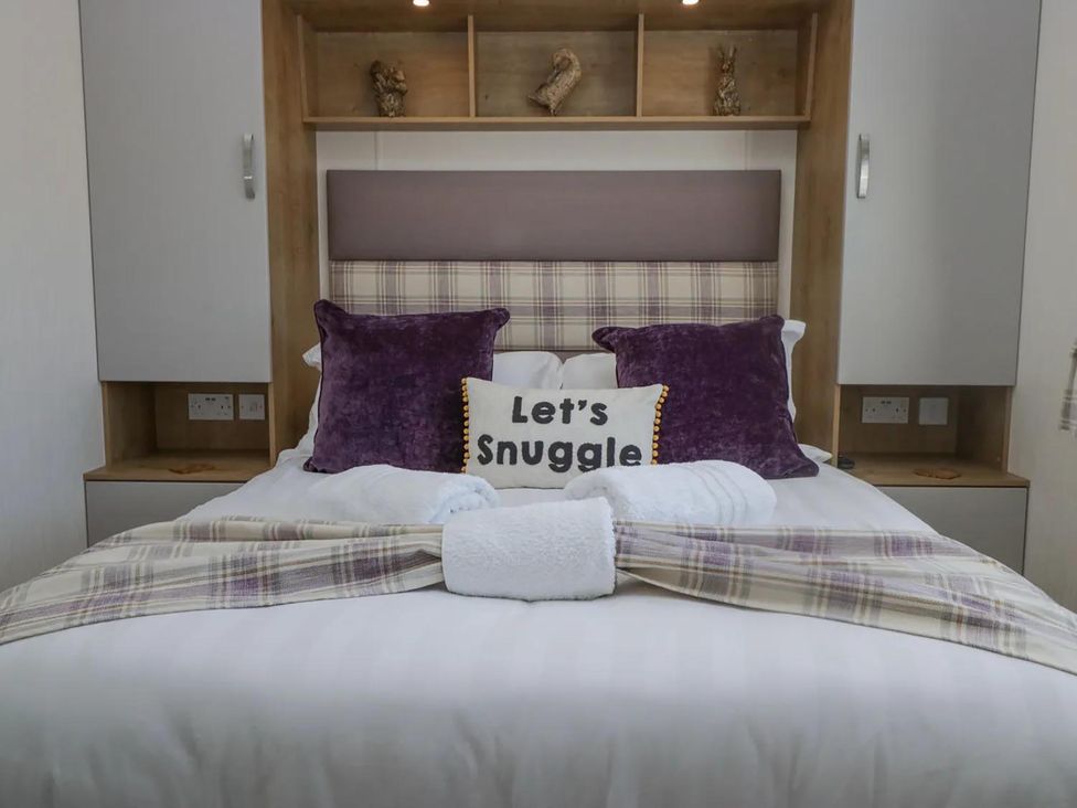 A bedroom with a bed and pillows at Lakeland Lodge 3Bed 2 Bath Private Patio in Carnforth