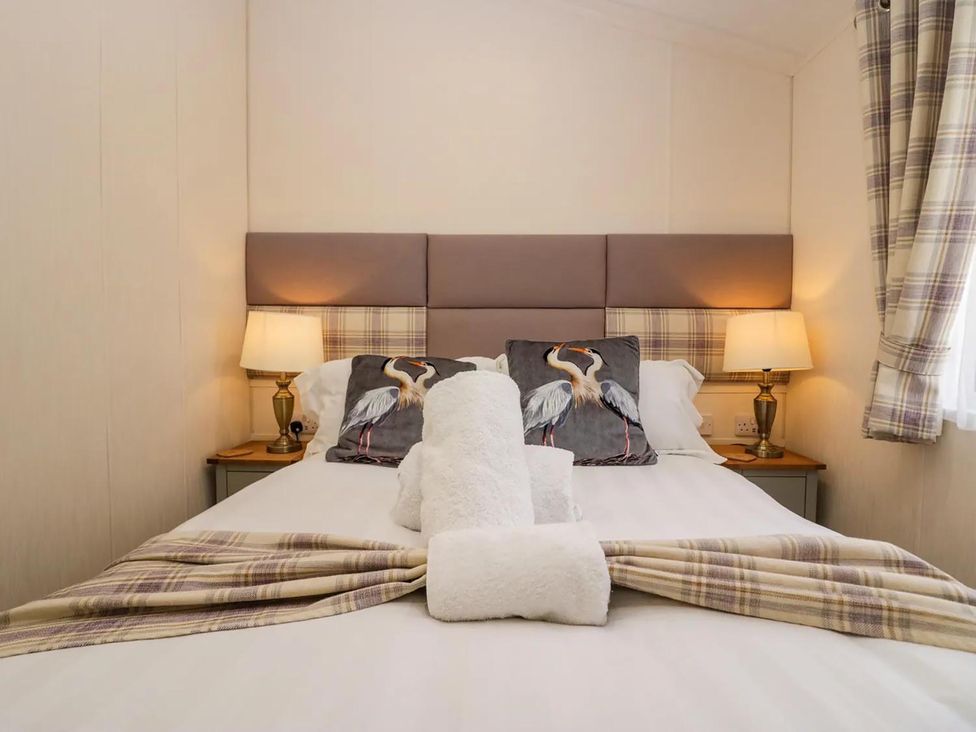 A bedroom with a bed and decorative pillows at Lakeland Lodge 3Bed 2 Bath Private Patio in Carnforth