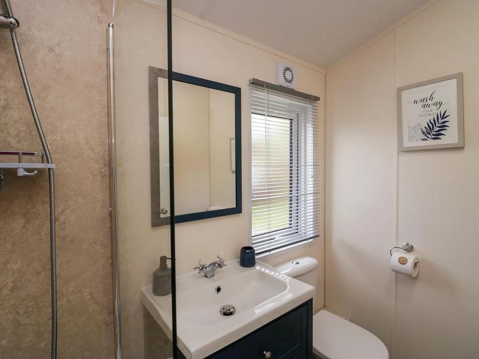 A bathroom with a shower, sink, and toilet at Lakeland Lodge 3Bed 2 Bath Private Patio in Carnforth