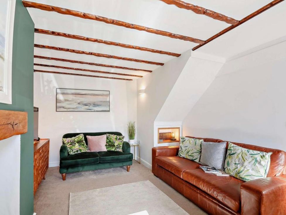 A living room with a sofa and armchair at Cottage Sleeps 5 with Parking and Garden in Carreglefn