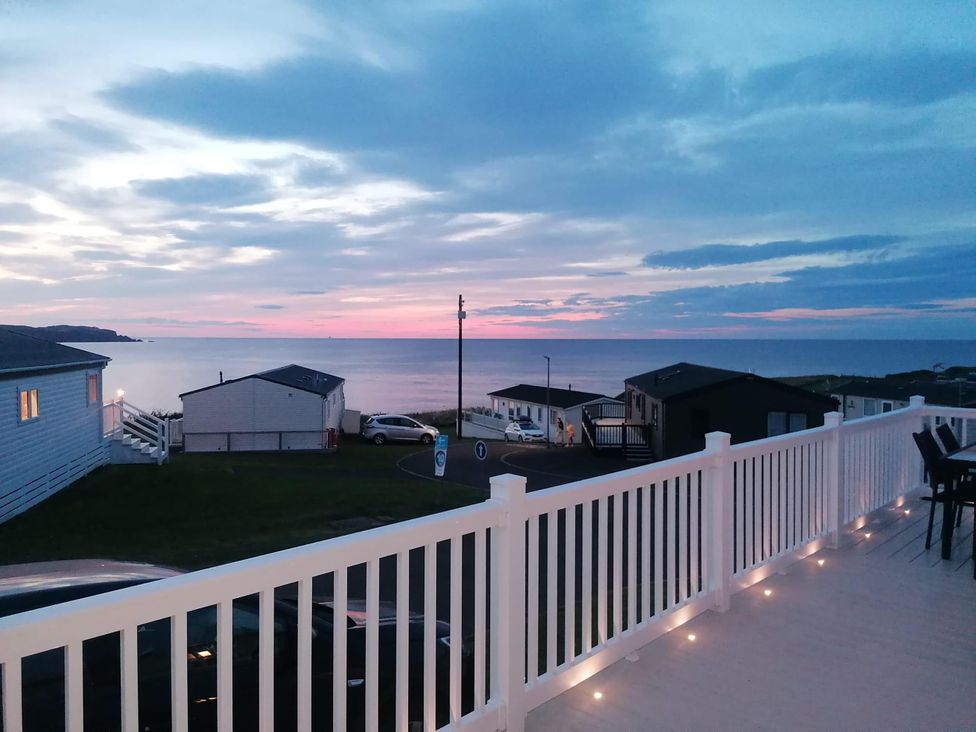 A view of the water and sky from a deck at Seaside Lodge Retreat in Eyemouth