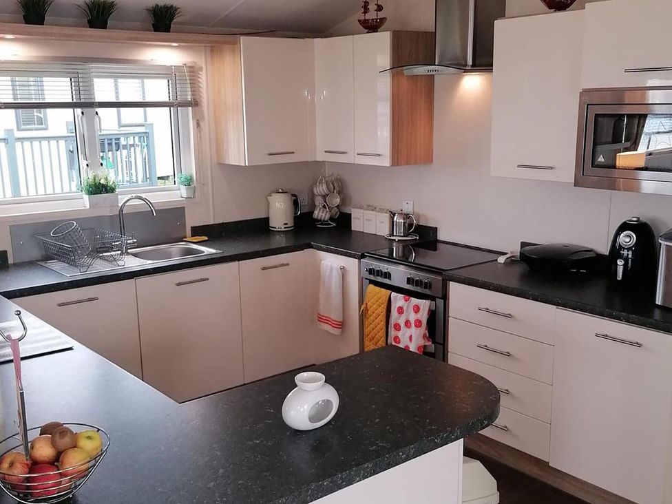 A kitchen with appliances and counter space at Seaside Lodge Retreat in Eyemouth