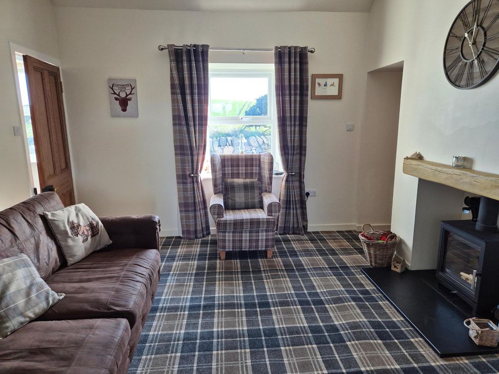 A living room with a sofa and armchair at Beautiful 2Bed semi rural cottage enclosed garden in Stranraer