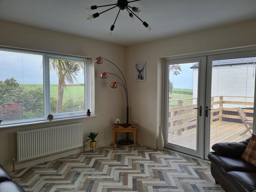 A living room with window and sliding door at Beautiful 2Bed semi rural cottage enclosed garden Stranraer