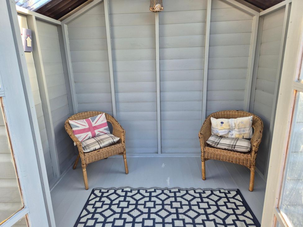 A snug with two chairs and a rug at Beautiful 2Bed semi rural cottage enclosed garden Stranraer