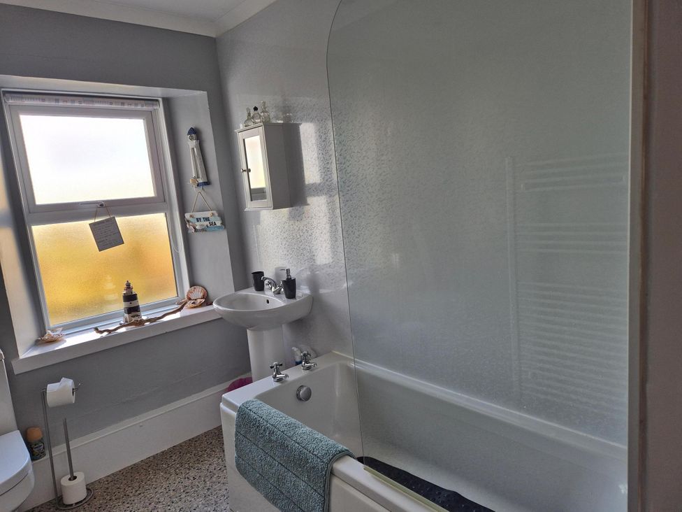 A bathroom with a bath and sink at Beautiful 2Bed semi rural cottage enclosed garden Stranraer