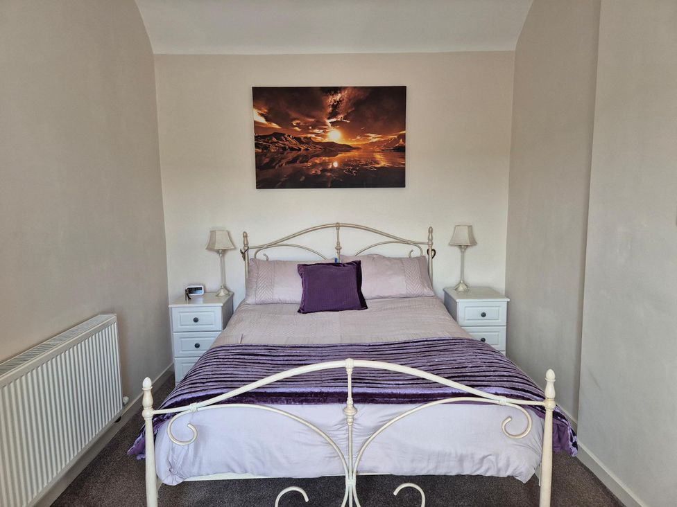 A bedroom with a bed and nightstands at Beautiful 2Bed semi rural cottage enclosed garden Stranraer