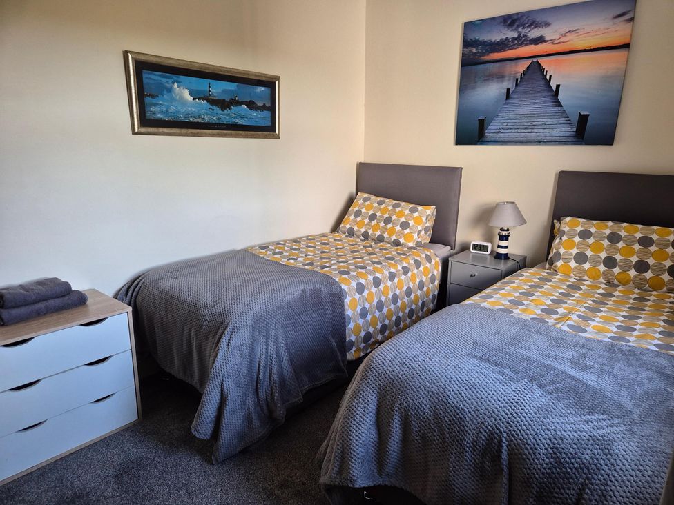 A bedroom with two beds and nightstands at Beautiful 2Bed semi rural cottage enclosed garden Stranraer