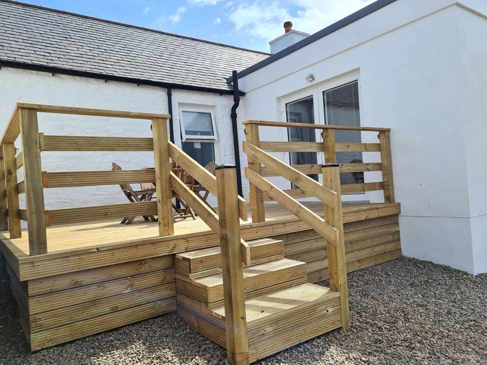 An outdoor deck with steps and a handrail at Beautiful 2Bed semi rural cottage enclosed garden Stranraer