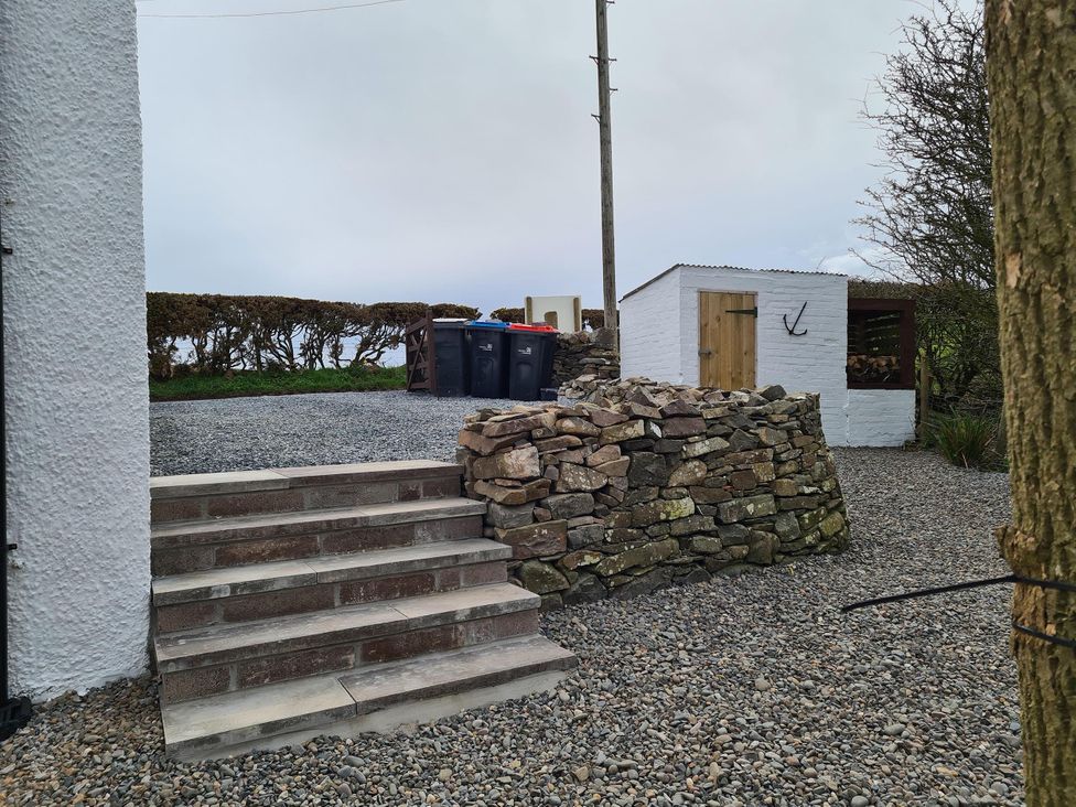 An outdoor area with steps and rubbish bins at Beautiful 2Bed semi rural cottage enclosed garden Stranraer