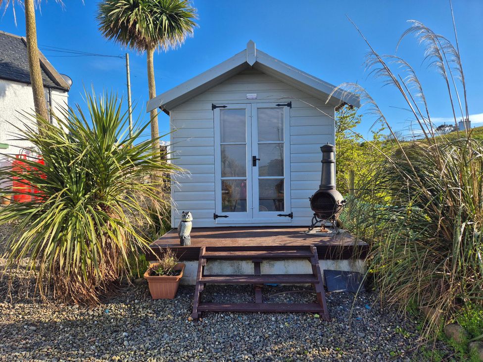 A garden shed with steps and plants at Beautiful 2Bed semi rural cottage enclosed garden Stranraer