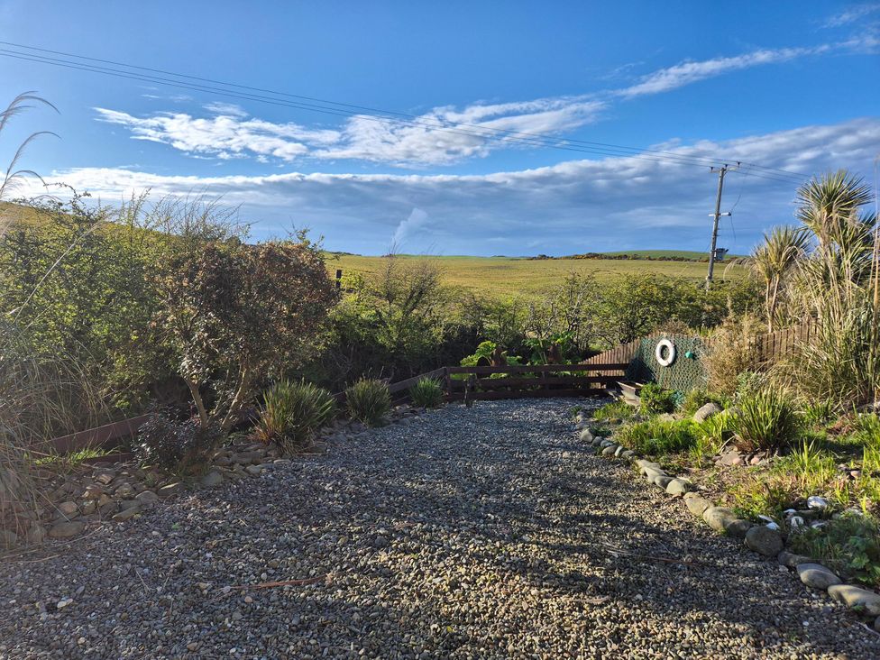 A garden with a gravel pathway and plants at Beautiful 2Bed semi rural cottage enclosed garden in Stranraer