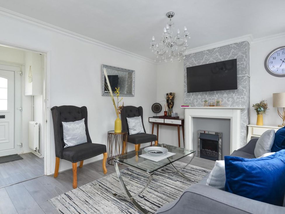 A living room with a sofa, coffee table and TV at Suspire House Sleeps 6 Garden Bbq Coastal retreat Near Valley