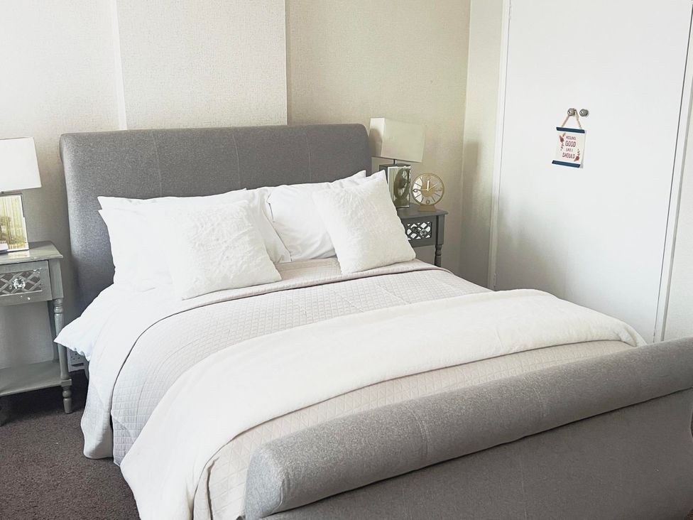 A bedroom with a bed and nightstand at Suspire House Sleeps 6 Garden Bbq Coastal retreat Near Valley