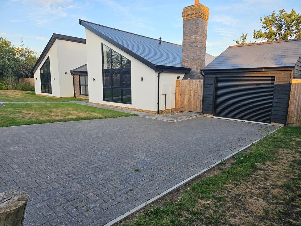 A house and garage with a driveway at Luxury Kent Bungalow Retreat Sleeps 12 Cross-at-Hand near Staplehurst