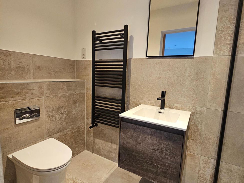 A bathroom with a toilet and sink at Luxury Kent Bungalow Retreat Sleeps 12, Cross-at-Hand near Staplehurst