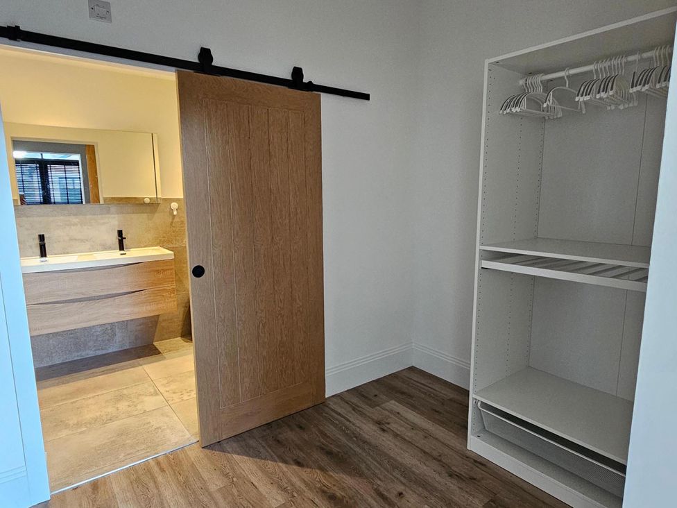 A bathroom with a sink and mirror at Luxury Kent Bungalow Retreat Sleeps 12 Cross-at-Hand near Staplehurst