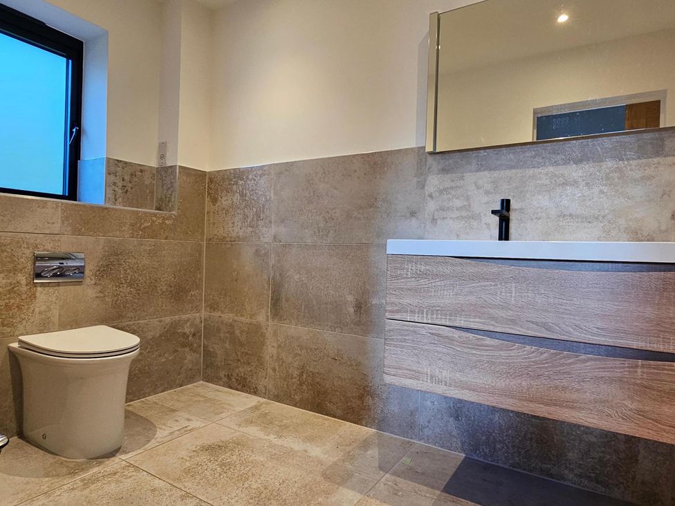 A bathroom with a toilet and sink at Luxury Kent Bungalow Retreat Sleeps 12 Cross-at-Hand near Staplehurst
