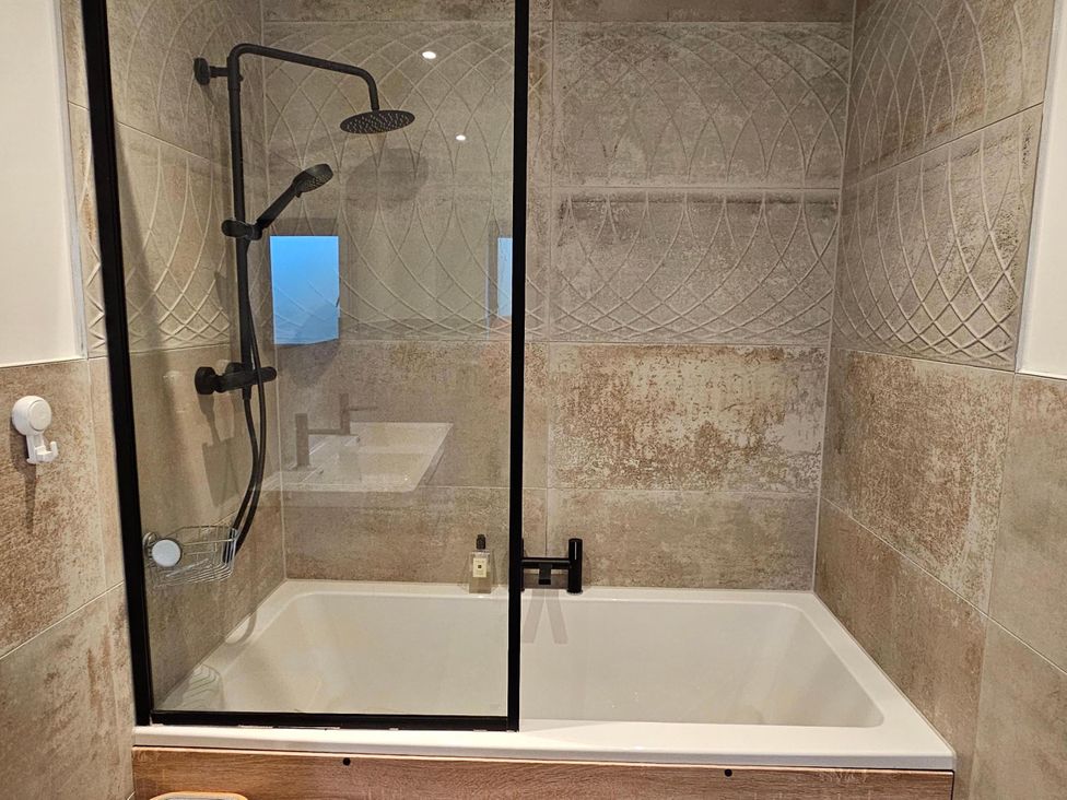 A bathroom with a shower and bath tub at Luxury Kent Bungalow Retreat Sleeps 12 in Cross-at-Hand near Staplehurst
