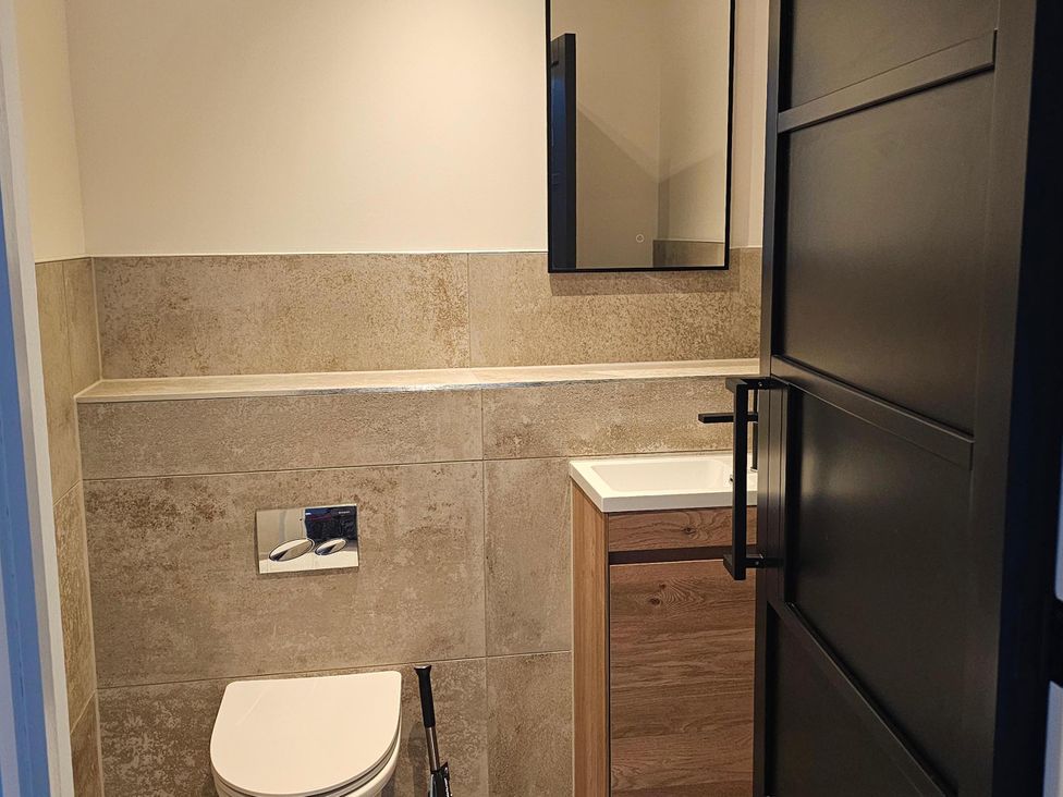 A bathroom with a toilet and sink at Luxury Kent Bungalow Retreat Sleeps 12 Cross-at-Hand near Staplehurst