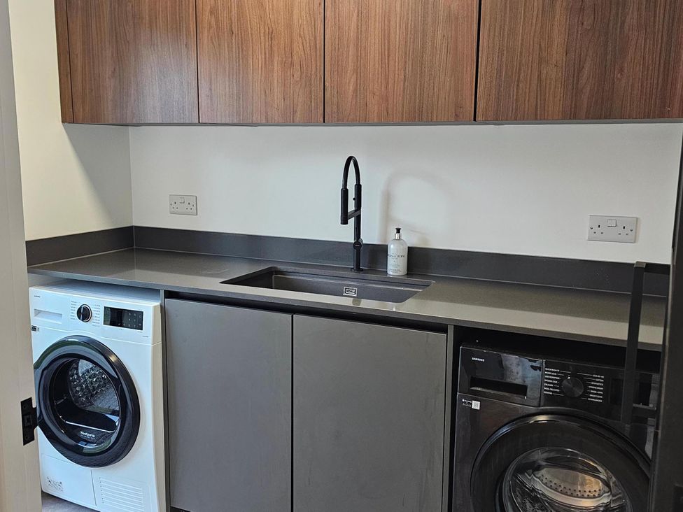 A utility room with a washing machine and dryer at Luxury Kent Bungalow Retreat Sleeps 12 Cross-at-Hand near Staplehurst