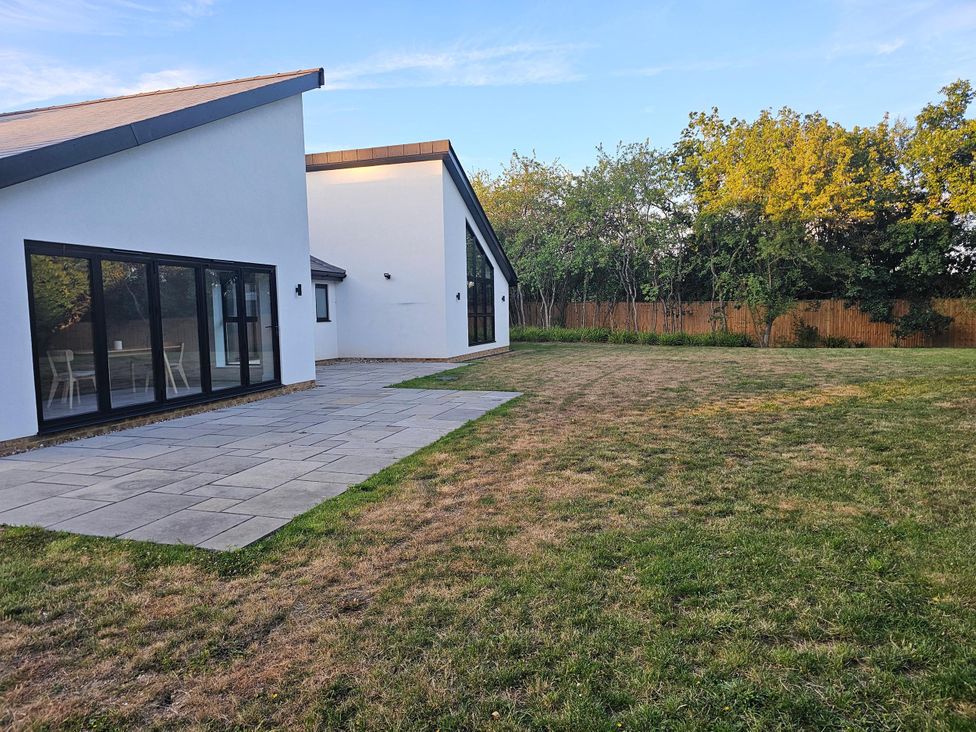 A house with a patio and lawn at Luxury Kent Bungalow Retreat Sleeps 12 in Cross-at-Hand near Staplehurst