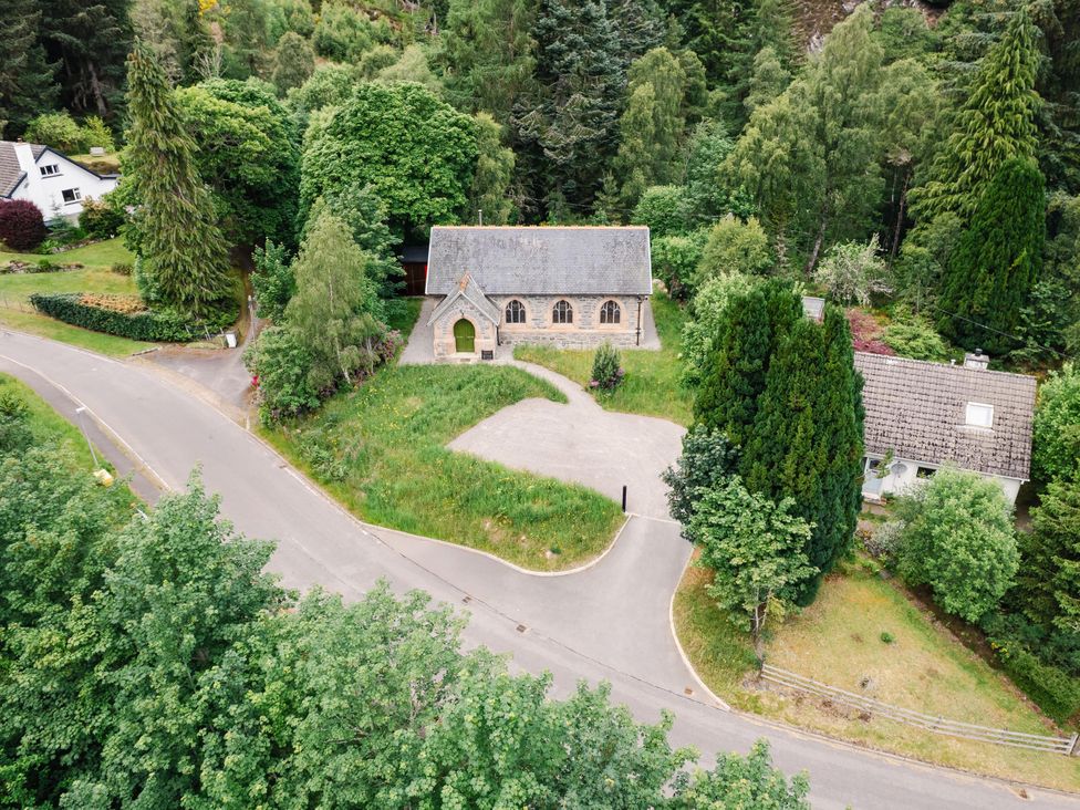 An aerial view of a church and nearby buildings at Grade C Church in Cannich