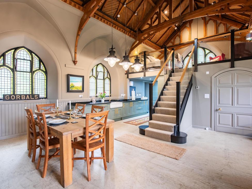 A dining room with a table and chairs at Grade C Church in Cannich