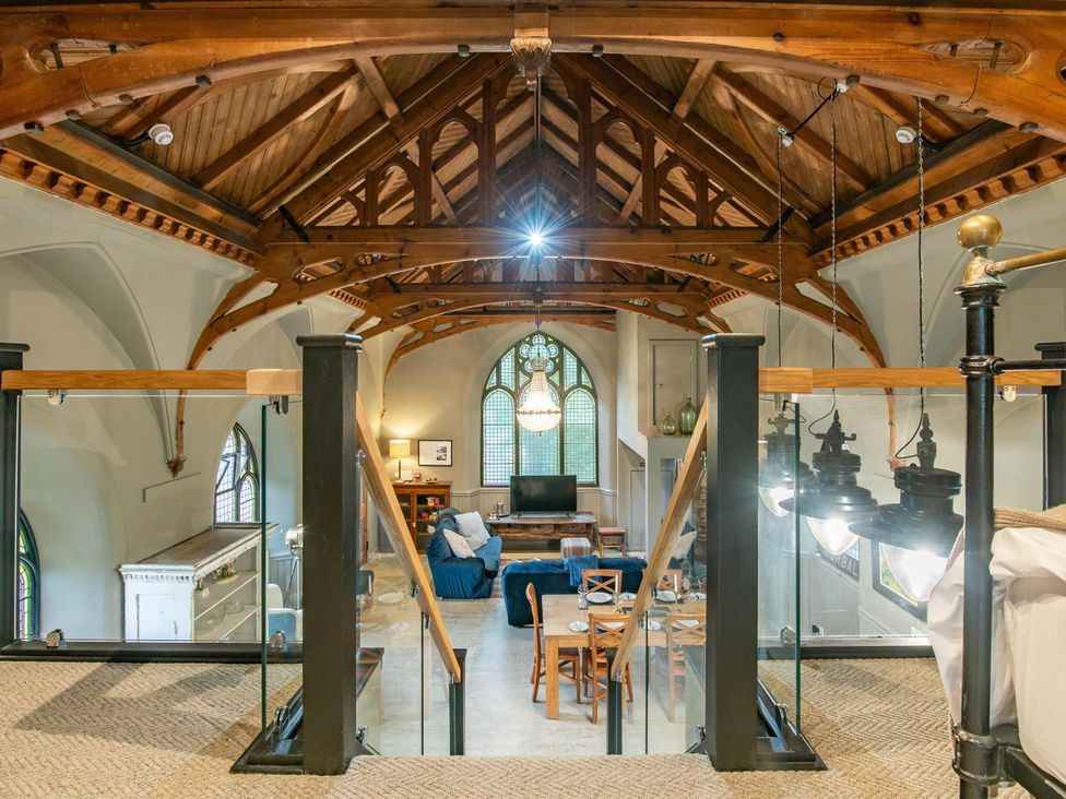 A living room with a sofa and dining area at Grade C Church in Cannich