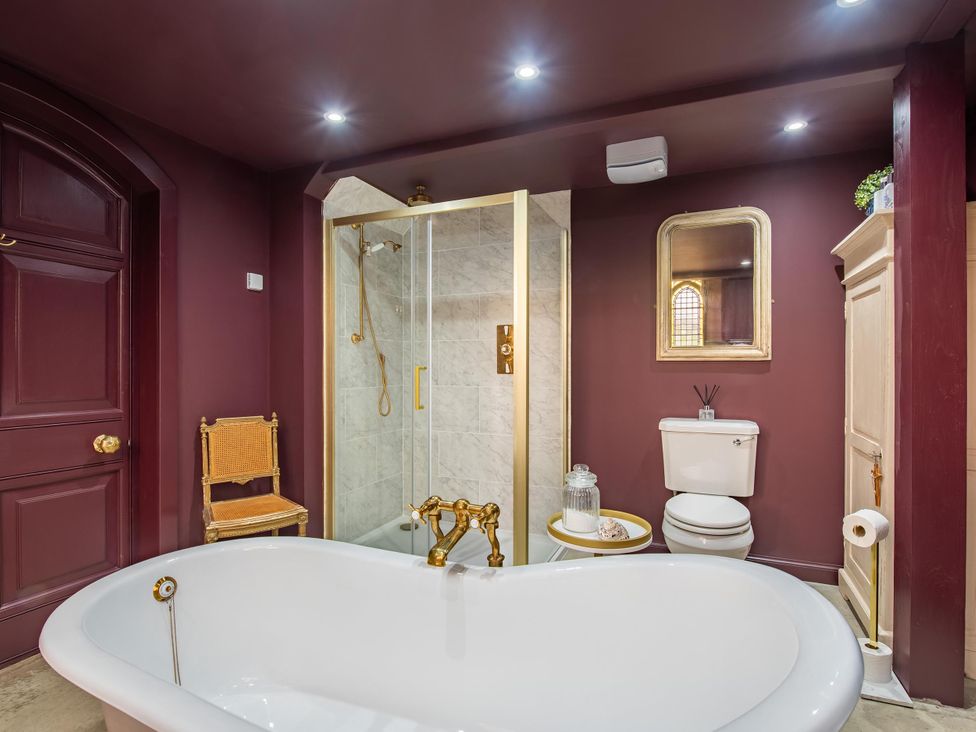 A bathroom with a bathtub and shower at Grade C Church in Cannich Sleeps 2 Parking Cannich