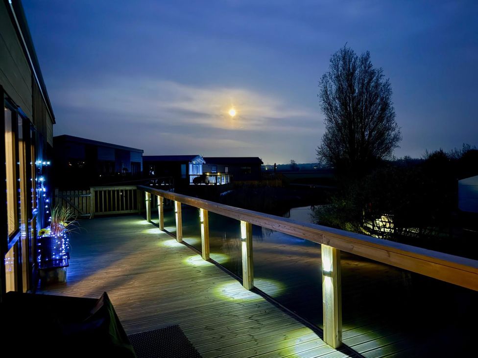 An outdoor space with decking and railings near water at Malton 2Bed Lodge Sleeps 4 Pet Friendly, Malton