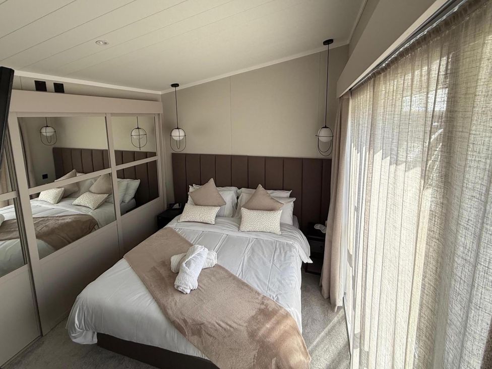 A bedroom with a bed and a mirror at Malton 2Bed Lodge Sleeps 4 Pet Friendly in Malton