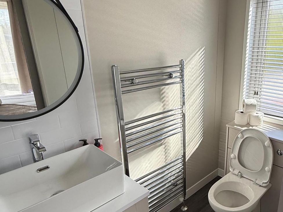 A bathroom with a sink, toilet, and towel rail at Malton 2Bed Lodge Sleeps 4 Pet Friendly in Malton