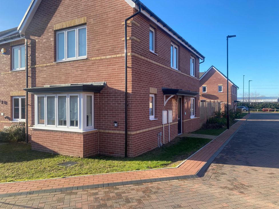 A house with a brick exterior and pathway at a residential area