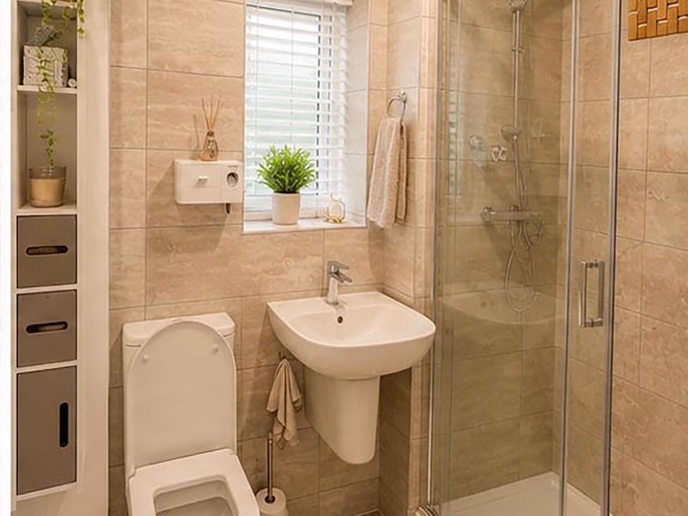 A bathroom with a toilet, sink, and shower at 