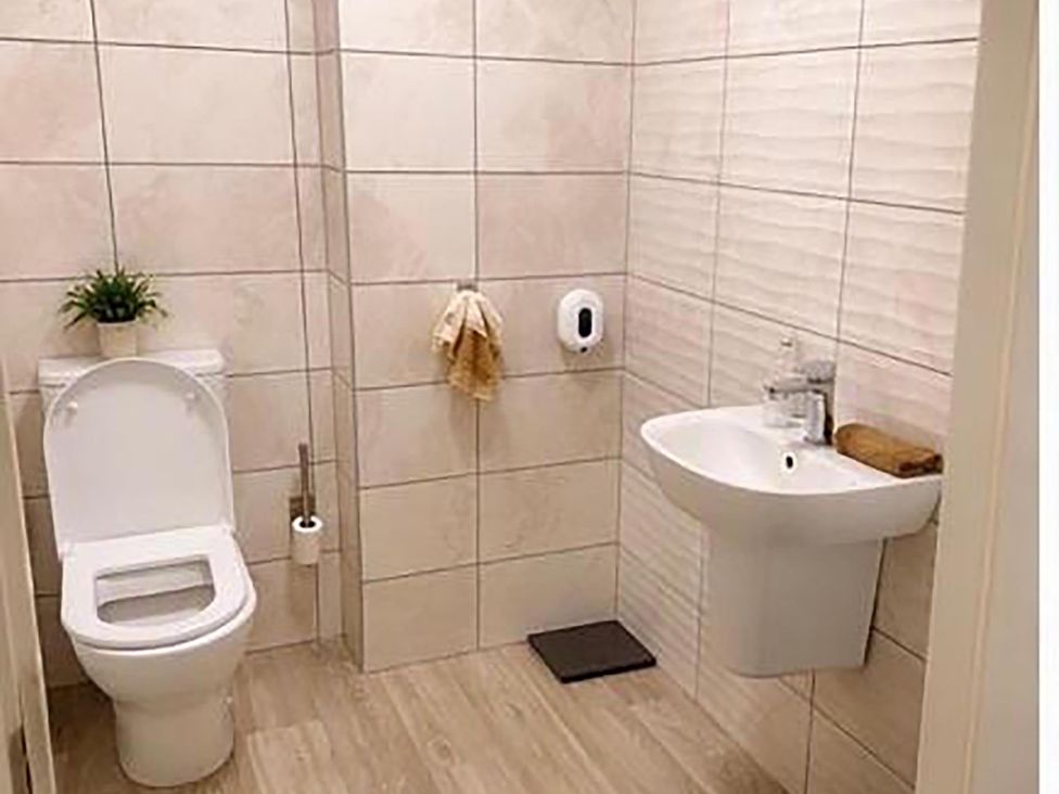 A bathroom with a toilet and sink at The Old Barn in Manchester