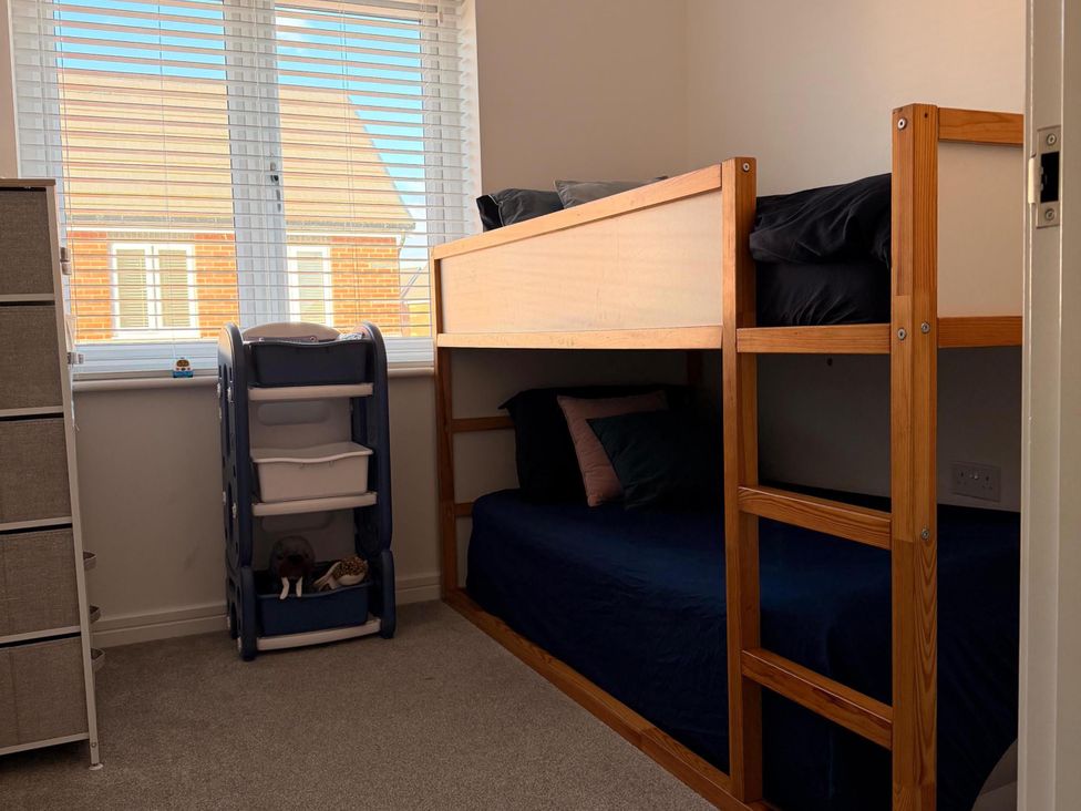 A bedroom with a bunk bed and dresser at the property