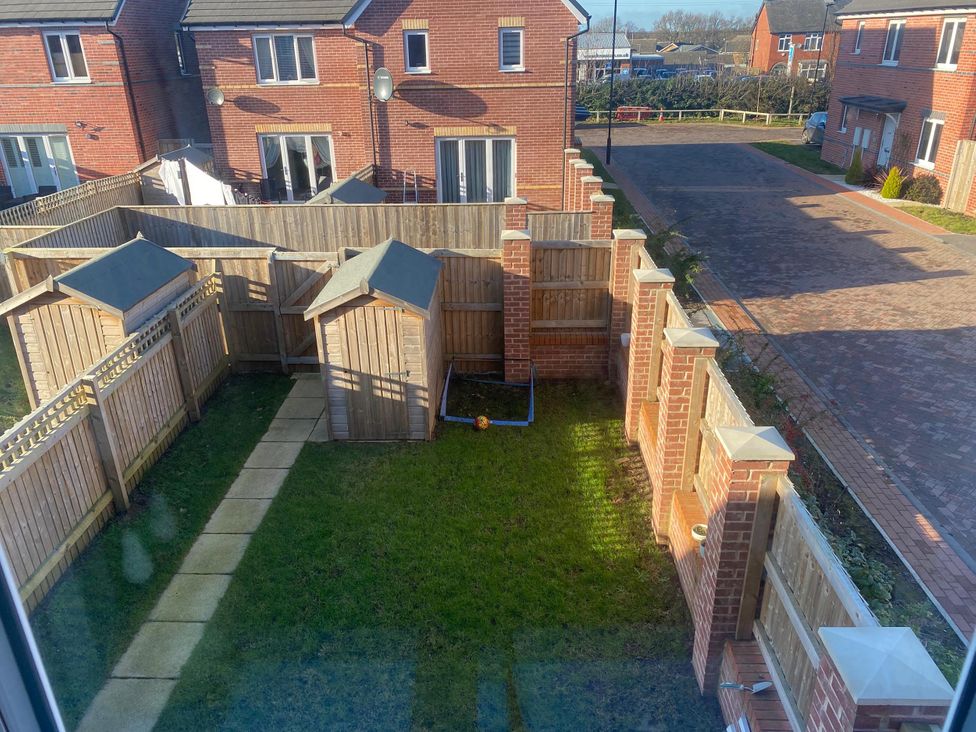 A garden with fences and sheds at the property