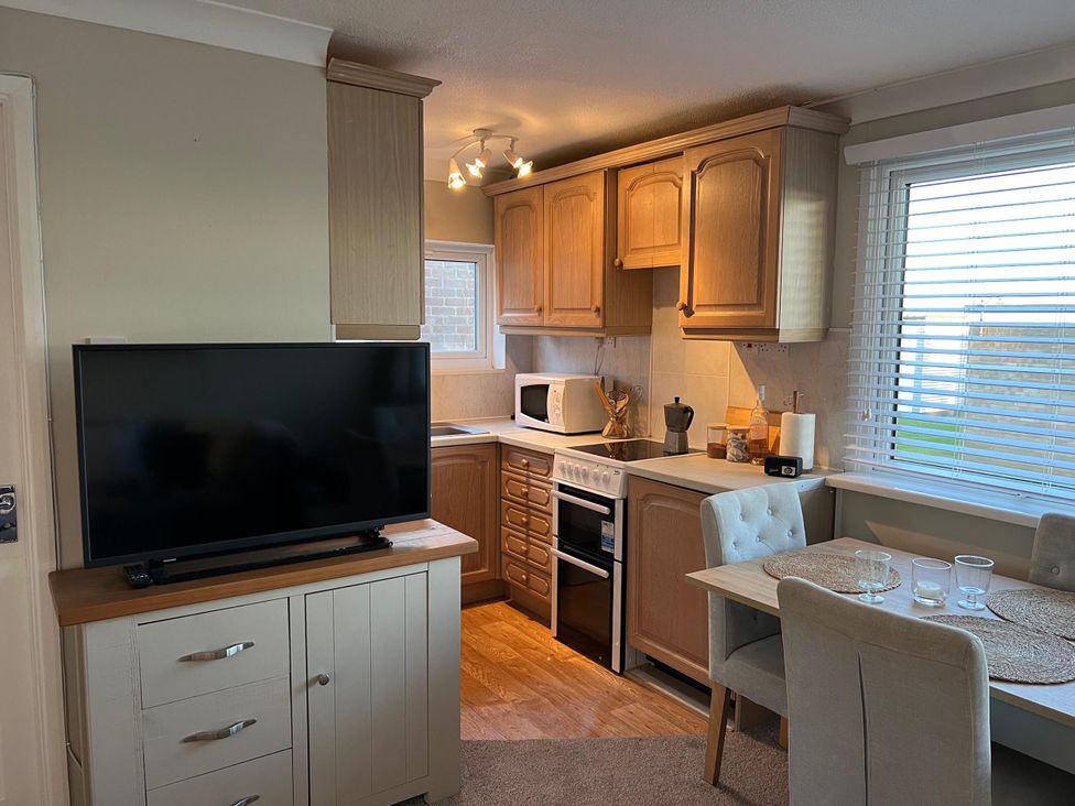 A kitchen with cabinetry and appliances at the property