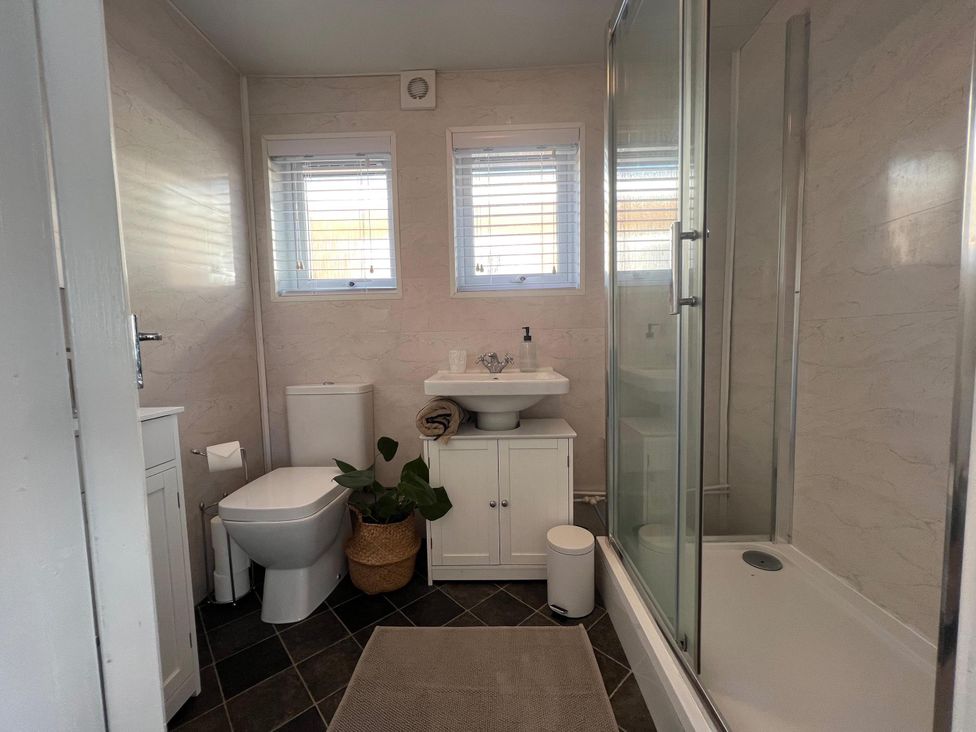 A bathroom with a toilet, sink and shower at the property