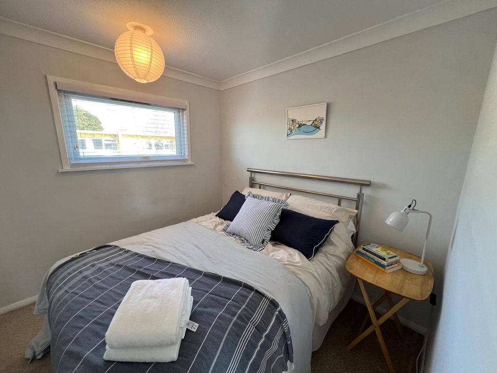 A bedroom with a bed and bedside table at The Old Barn in Manchester