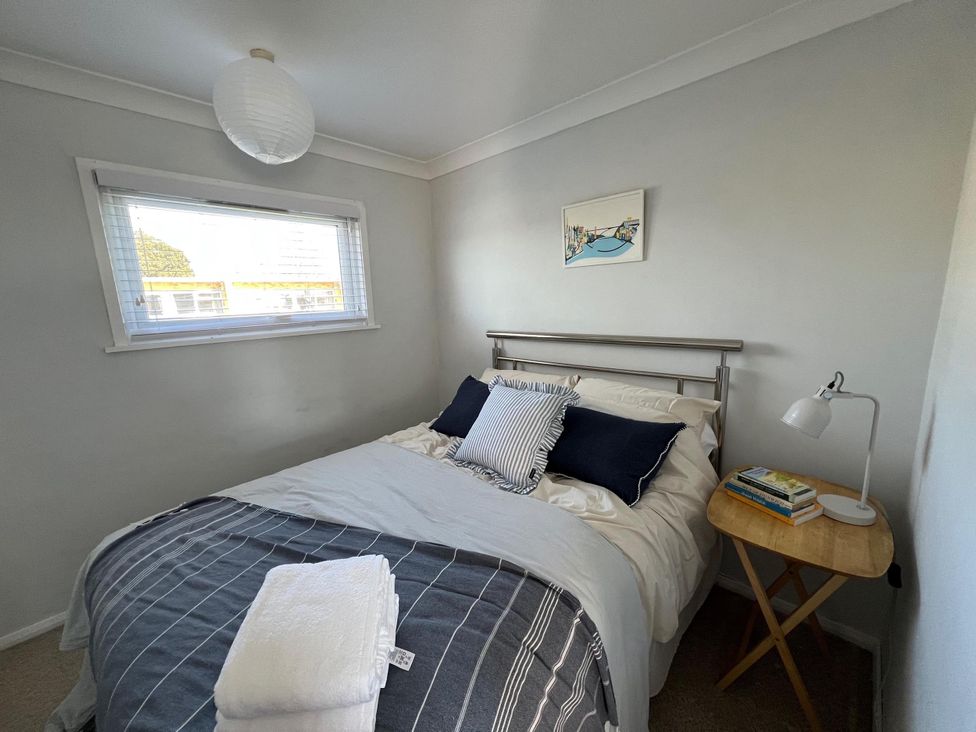 A bedroom with a bed and bedside table at The Old Barn in Manchester