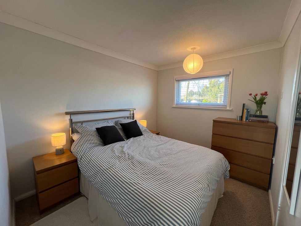 A bedroom with a bed and nightstands at the property in location