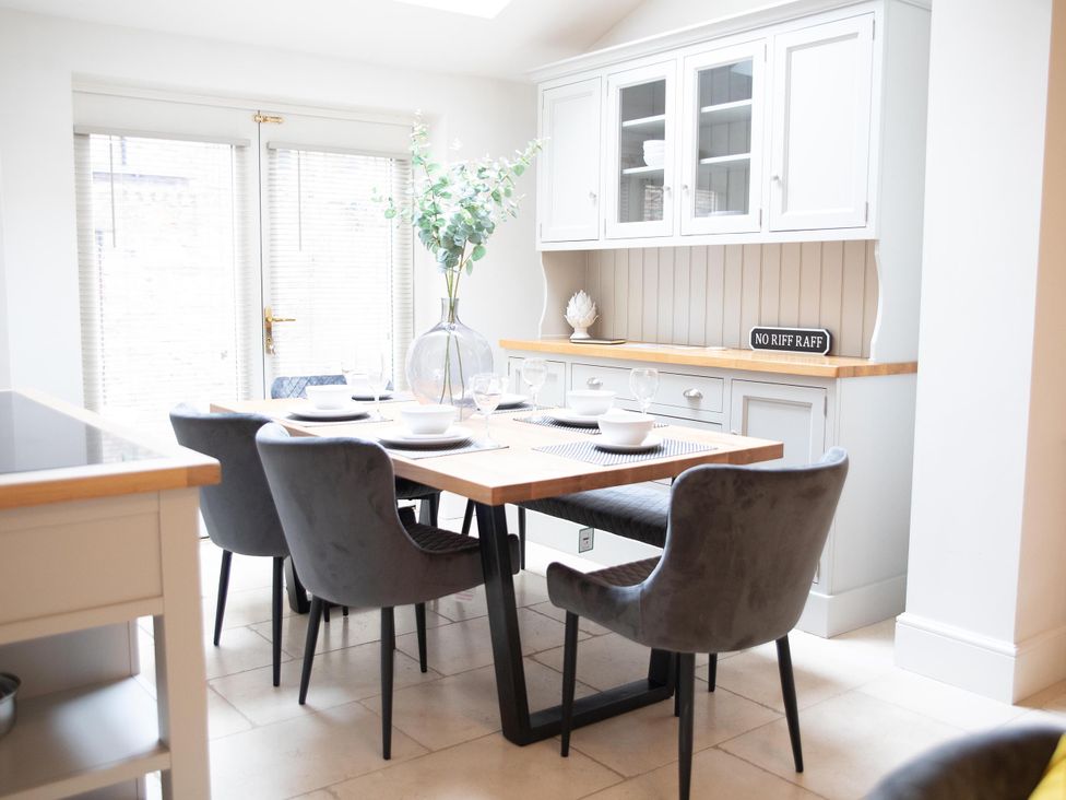 A dining room with a table set for six at York Minster 3bed Sleeps 6 Fireplace Free Parking, York