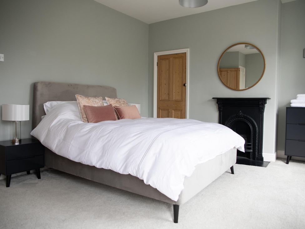 A bedroom with a bed and nightstand at York Minster 3bed Sleeps 6 Fireplace Free Parking, York