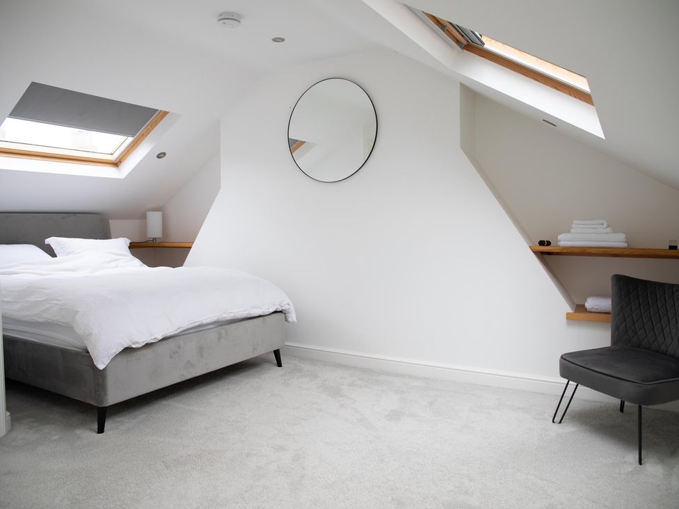 A bedroom with a bed and a chair at York Minster 3bed Sleeps 6 Fireplace Free Parking, York