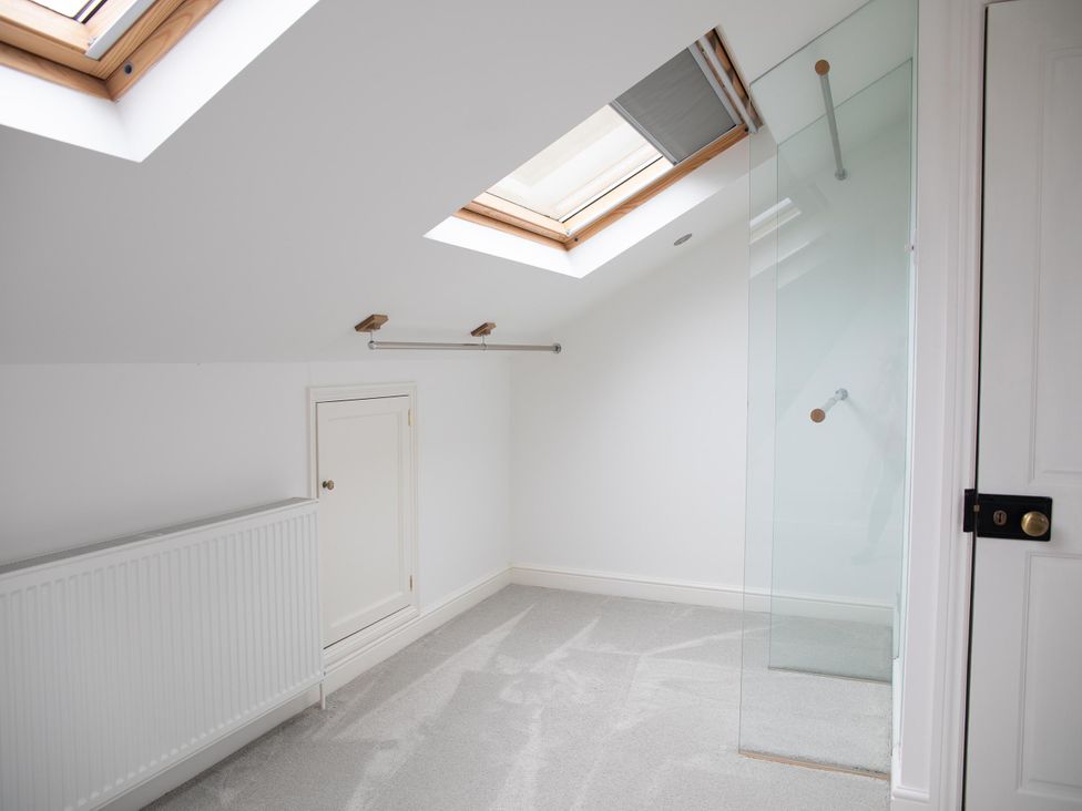 A bathroom with skylights and a glass shower partition at York Minster 3bed Sleeps 6 Fireplace Free Parking, York