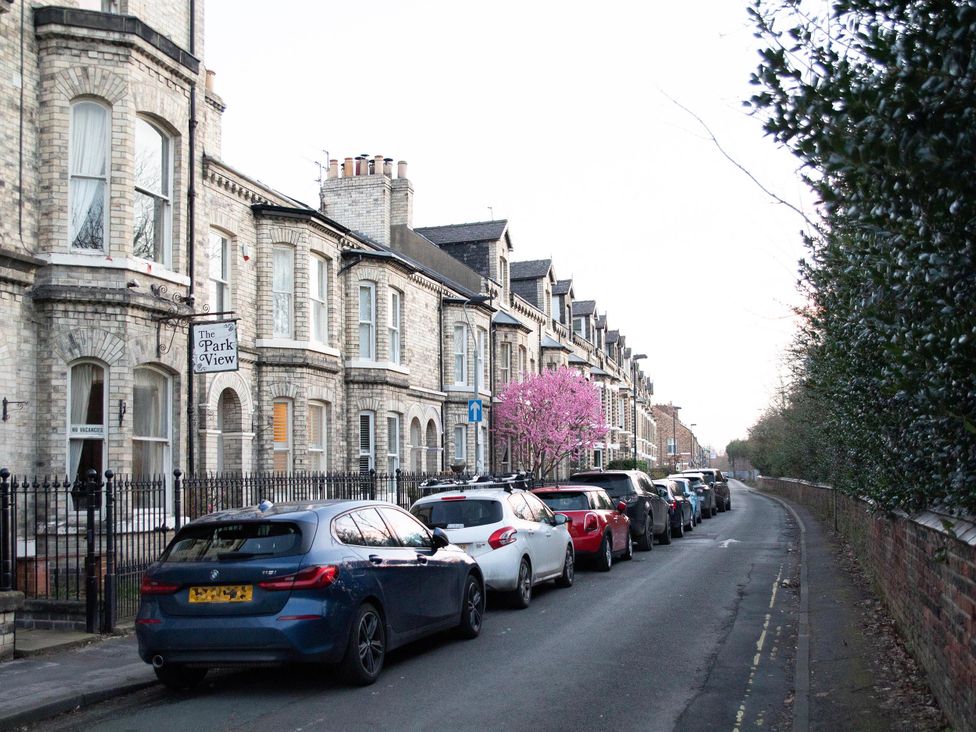 A street lined with houses and parked cars at The Park View in York